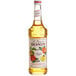 A bottle of Monin apple syrup with a label.