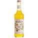 A Monin bottle of yellow passion fruit syrup.