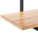 A Cal-Mil Madera rustic pine 3-shelf display riser with black metal legs and a black base.