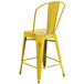 A Flash Furniture yellow metal counter height stool with a vertical slat back and drain hole seat.