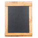 A blackboard in a wooden frame on a table.