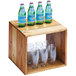 A Cal-Mil Madera rustic pine cube riser on a wooden table with bottles and glasses.