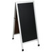 An Aarco aluminum A-frame black chalkboard with white frame.