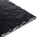A black rectangular serving platter with a shiny surface that looks like black tile.