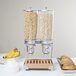 A Cal-Mil double cereal dispenser with beechwood accents containing cereal.