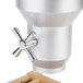 A close-up of a Cal-Mil beechwood cereal dispenser with a silver cylinder.
