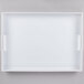 A white rectangular Cal-Mil plastic room service tray with handles.