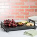 A black Cal-Mil rectangular melamine serving platter with grapes and cheese on it.