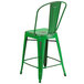 A Flash Furniture green metal restaurant bar stool with a slat back and drain hole seat.