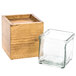A wooden box with a square glass jar inside.