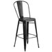 A black metal Flash Furniture bar stool with a vertical slat back.