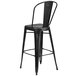 A Flash Furniture black metal bar stool with a backrest.