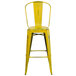 A Flash Furniture yellow metal bar stool with vertical slat back.