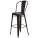 A Flash Furniture black distressed copper metal bar stool with a backrest and drain hole seat.