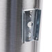 A close-up of a San Jamar stainless steel wall mount lid holder.