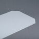 A white translucent Metro shelf inlay on a gray surface.