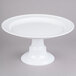 A white plate on a round white pedestal stand.