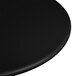 A close-up of a black Elite Global Solutions melamine plate on a black surface.