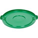 A green plastic lid for a Continental 44 gallon round trash can with a circle in the middle.