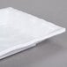 A white rectangular melamine tray with a wavy edge.