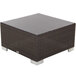 A brown wicker square ottoman with a white base.