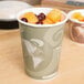 A Eco-Products Evolution World soup and food cup filled with fruit.