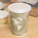 A white Eco-Products Evolution World soup cup with a lid on a table.