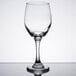 A close-up of a Libbey Perception wine goblet with pour lines on a reflective surface.