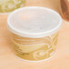 A white Eco-Products Evolution World paper food container with a lid.