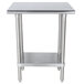 A stainless steel Advance Tabco work table with a stainless steel shelf.