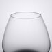 A close up of a clear Spiegelau Cognac glass with a black rim.