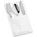 A white pocket fold napkin containing heavy weight silver plastic cutlery.