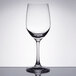 A Spiegelau Vino Grande white wine glass on a reflective surface.