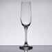 A clear Spiegelau Soiree flute glass on a reflective surface.