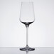 A Spiegelau Hybrid white wine glass on a table with a reflection.