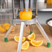 A Garde WEDGE4 fruit wedge cutter slicing an orange.