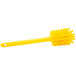 A close-up of a yellow Carlisle bottle cleaning brush with a handle.