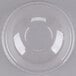 A clear plastic dome lid with a hole on a white surface.