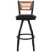 A BFM Seating black metal bar stool with a cherry wood back and black vinyl seat.