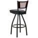 A BFM Seating black metal bar stool with a black wooden back and seat.