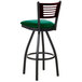 A BFM Seating bar stool with a green vinyl seat and mahogany wooden back on black metal legs.