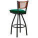 A BFM Seating bar stool with a green vinyl seat and cherry wood back.