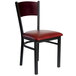 A black metal BFM Seating side chair with mahogany wood and burgundy vinyl seat.