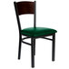 A BFM Seating black metal side chair with a walnut wooden back and green vinyl seat.