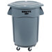 A Rubbermaid grey plastic trash can with wheels.