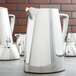 A close-up of a Vollrath stainless steel water pitcher.