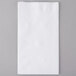 A white Response rectangular dinner napkin on a gray surface.