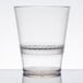 A WNA Comet clear plastic rocks glass with a clear rim.