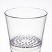 A clear plastic rocks glass with a strainer at the bottom.