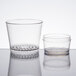 A pair of clear plastic cups with a clear strainer lid.